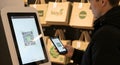 Customer Using Smartphone to Scan QR Code on Self-Service Kiosk for Payment or Information Royalty Free Stock Photo