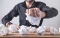 Man making crumpled paper balls on the table