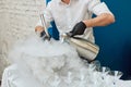 Man making cryogenic ice cream using liquid nitrogen and steam from dry ice