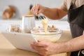 Man making dough while watching online cooking course via tablet in kitchen, closeup Royalty Free Stock Photo