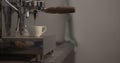 Man making espresso with single spout portafilter on coffee machine
