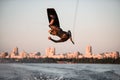 man making extreme trick in jump time with wakeboard on sky background. Royalty Free Stock Photo