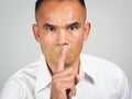 The man making finger on lips silence gesture, pst, shh Royalty Free Stock Photo