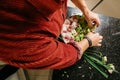 Man making flowers arrangment with green and white orhids