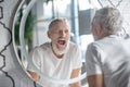 Man making funny faces near the mirror Royalty Free Stock Photo