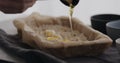 man making granola at home, pour honey