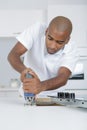 Man making hole for ceramic hob with jigsaw Royalty Free Stock Photo