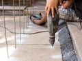 Man making a hole in the concrete floor using a drill Royalty Free Stock Photo