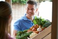 Man Making Home Delivery Of Organic Vegetable Box Royalty Free Stock Photo