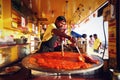 Man making Pao Bhaji in a giant pan at Juhu Beach, India