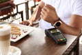 Man making payment with smart watch in cafe, closeup Royalty Free Stock Photo