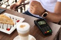 Man making payment with smart watch in cafe, closeup Royalty Free Stock Photo