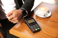 Man making payment with smart watch in cafe, closeup Royalty Free Stock Photo