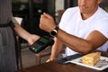 Man making payment with smart watch in cafe, closeup Royalty Free Stock Photo