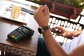 Man making payment with smart watch in cafe, closeup Royalty Free Stock Photo