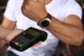 Man making payment with smart watch outdoors, closeup Royalty Free Stock Photo
