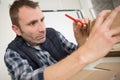 man making pencil mark on cardboard box Royalty Free Stock Photo