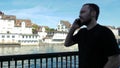 Man making phone call walking on the street. Royalty Free Stock Photo