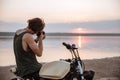 Man making photo with camera while sitting on his motocycle Royalty Free Stock Photo