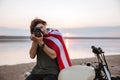 Man making photo with camera while sitting on his motocycle Royalty Free Stock Photo