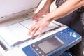 Man making photocopy using copier in office