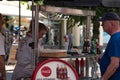 Man making purchase at outdoor food cart street vendor in this tourist town