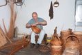 Man is making reed baskets in a braiding factory at Madeira,