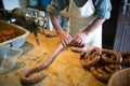 Man making sausages the traditional way using sausage filler. Royalty Free Stock Photo