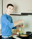 Man making scrambled eggs in frying pan Royalty Free Stock Photo