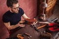 Man making shoes for customers. individual order