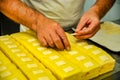 man making small yellow cakes