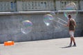 Man making soap bubble on the promenade of city Zug in Switzerland.