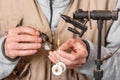 Man making trout flies. Fly tying equipment and material for fly fishing preparation. Royalty Free Stock Photo