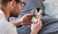 Man making video call with parents using smartphone Royalty Free Stock Photo