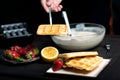 Man making waffles on a waffle machine Royalty Free Stock Photo