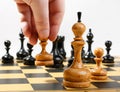 Man making the white pawn move in a chess game Royalty Free Stock Photo