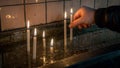 Man making a wish with sacred burning candles in church in Saint Antoine church in Taksim Royalty Free Stock Photo