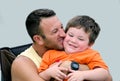 Man Man hugging laughing little boy Royalty Free Stock Photo