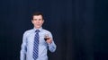 Man manager in business shirt holds glass in hand, tastes wine and tries to understand its aroma.