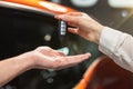 Man manager giving keys from brand new car to his woman client , successful purchase deal, cooperation