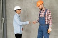 Man manager pays for the work of foreman builder repairman with dollar money. construction site. Focus on hands with Royalty Free Stock Photo