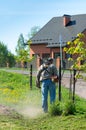 Man with a manual lawn mower mows the grass Royalty Free Stock Photo