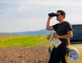 Man with map and binoculars at countryside Royalty Free Stock Photo