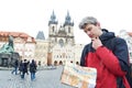 Man with map over tourist attraction