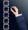 Man with marker and check boxes with ticks on dark background, closeup Royalty Free Stock Photo