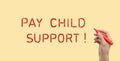 Man with marker and phrase PAY CHILD SUPPORT! on beige background, closeup. Banner design
