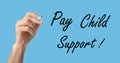 Man with marker and phrase PAY CHILD SUPPORT! on turquoise background, closeup. Banner design