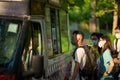 Man with a mask buying ice cream in a food truck in Shing Mun Reservoir, Hong Kong on a sunny day.