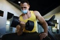 Man With Mask Doing Biceps Exercises With Dumbbells In The Gym. Royalty Free Stock Photo