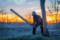 A man in a mask and goggles with a stick in his hands, post-apocalypse